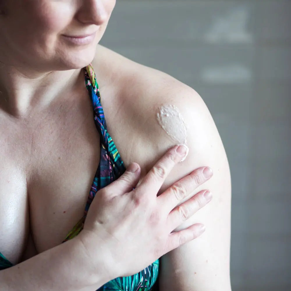 Body butter on womans shoulder