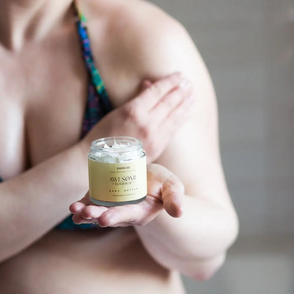 Body Butter on Womans shoulder with Body Butter in Hand