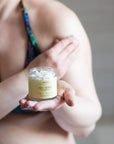 Body Butter on Womans shoulder with Body Butter in Hand