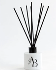 White Awesome Botanical reed diffuser with AB logo and black reeds