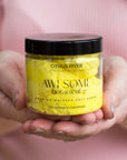 Citrus River Yellow Salt Body Scrub in hand