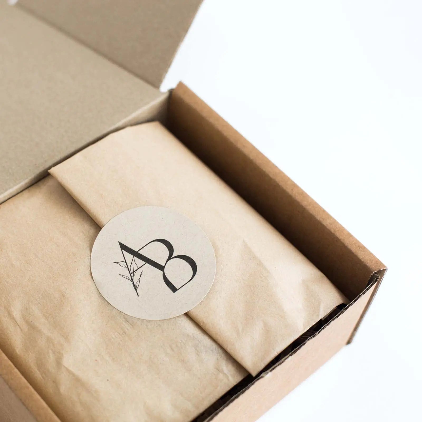 Closed Monthly Subscription Box with kraft paper and sealed with Awesome Botanical Logo sticker