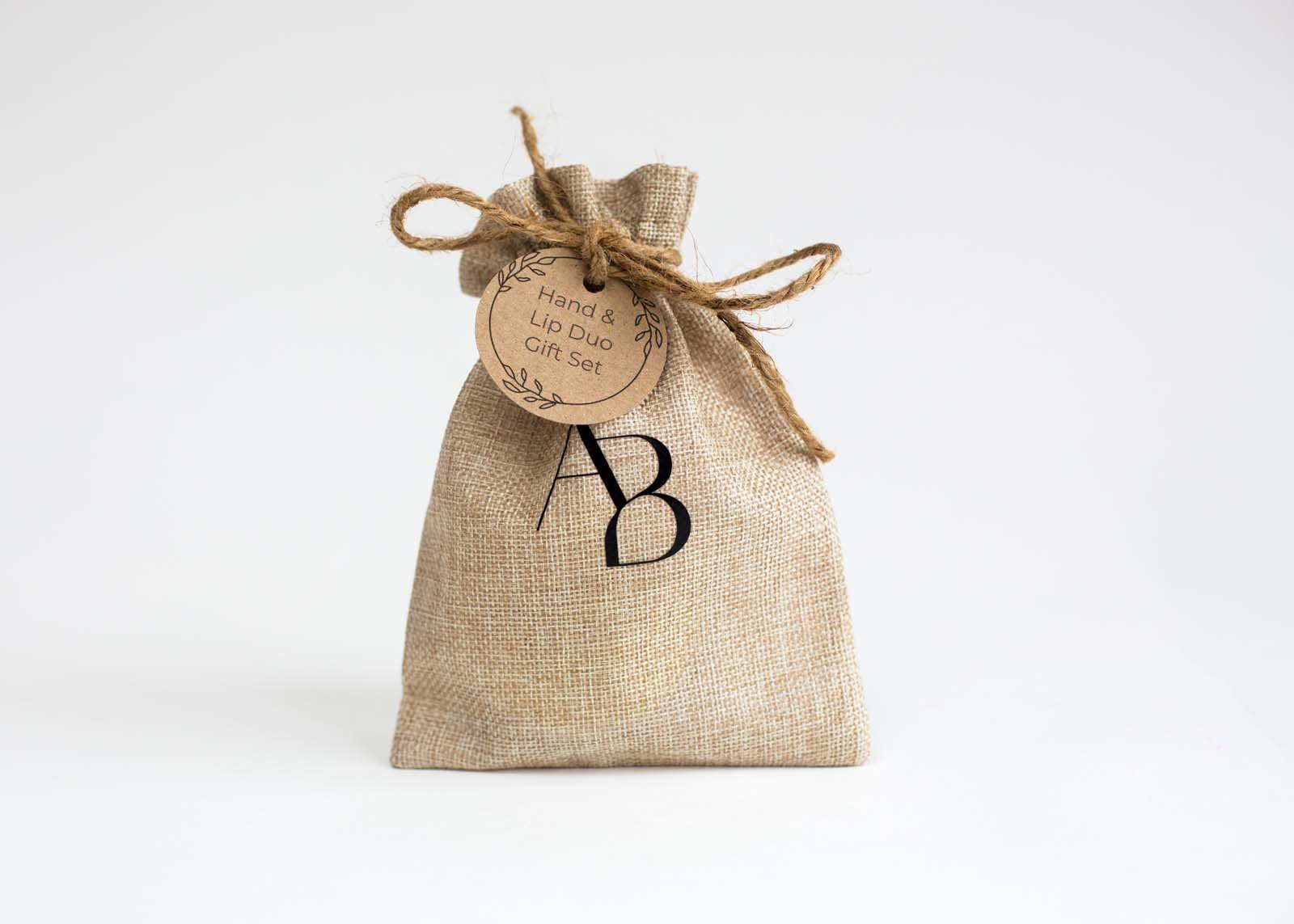 Branded Awesome botanical hessian bag with gift tag on white background