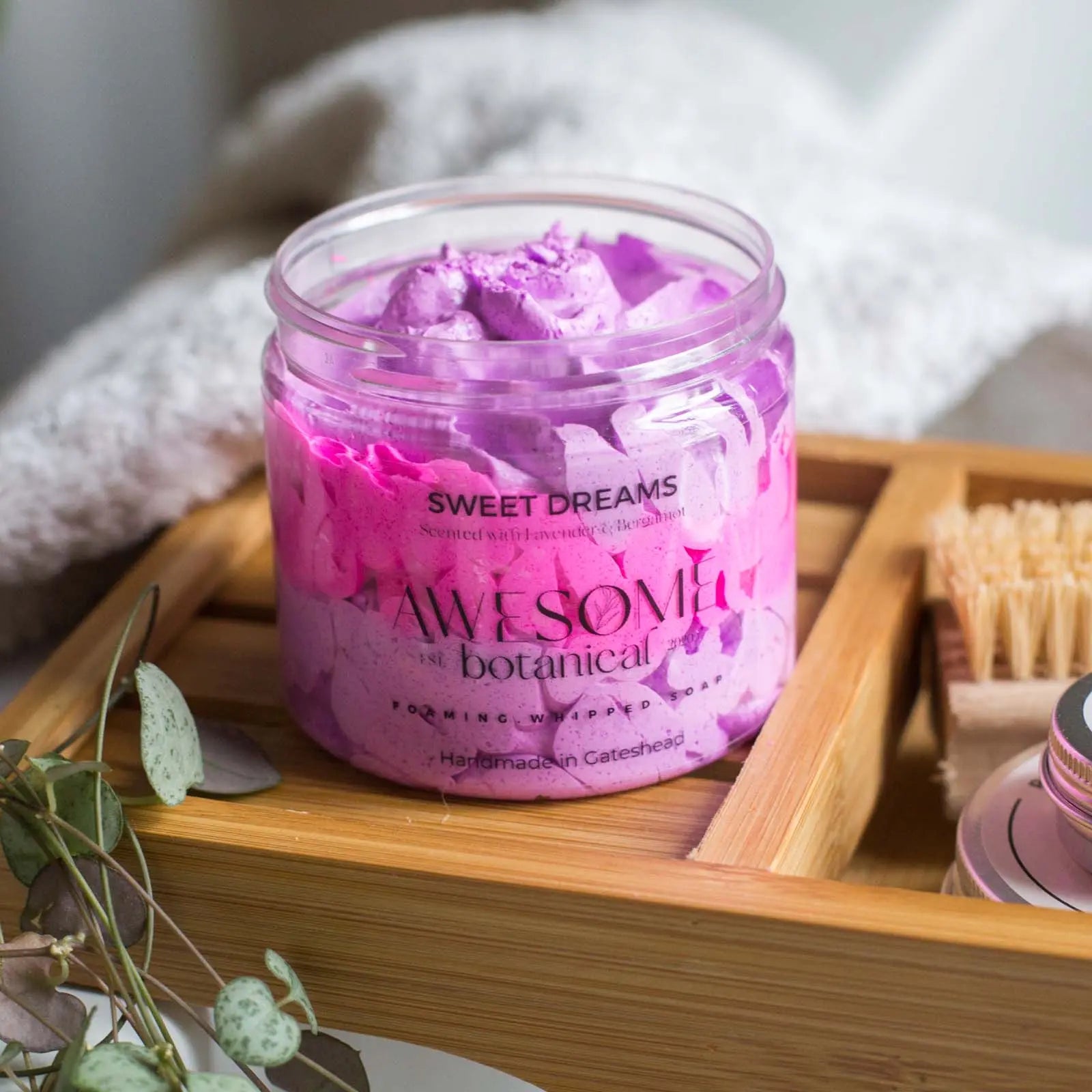 Sweet Dreams whipped soap pink & purple on bath rack with towel and leaves