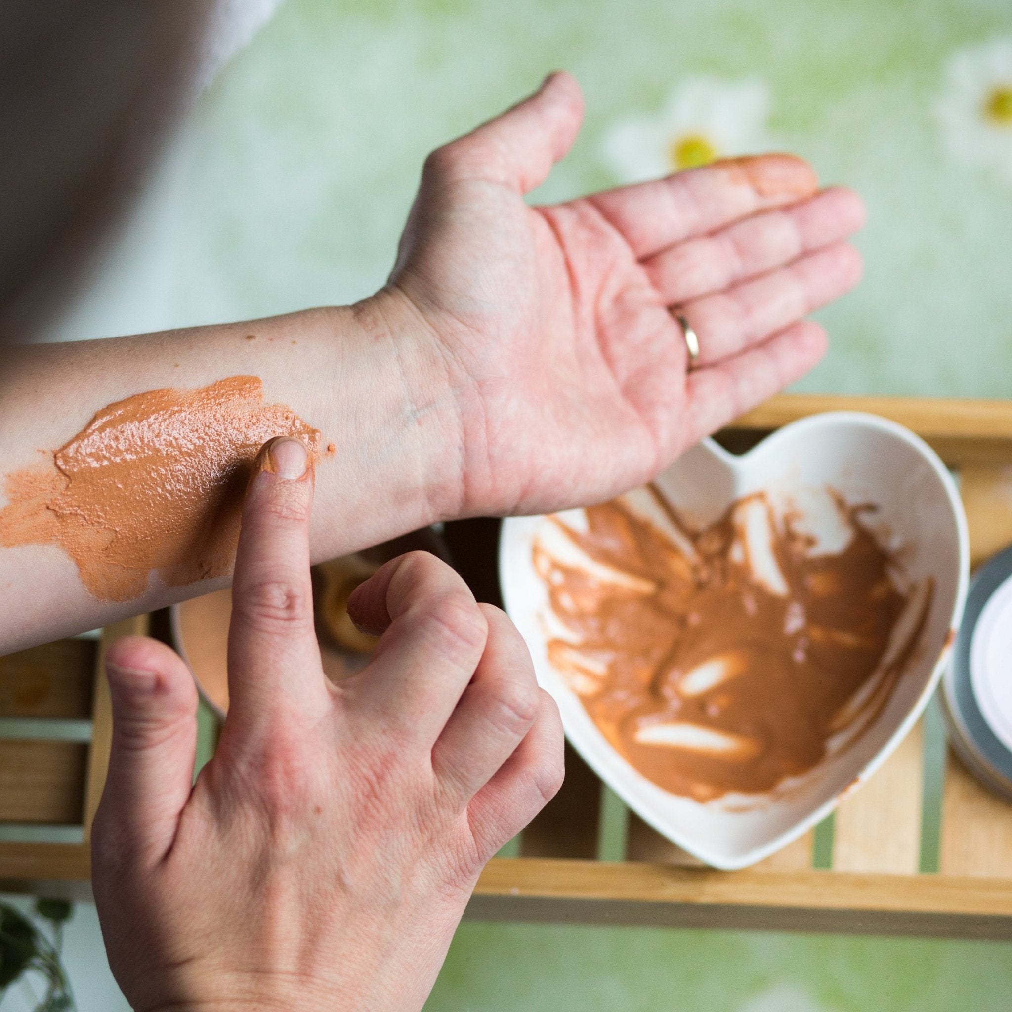 Pink Clay Mask on womans arm