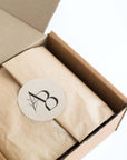 Closed Monthly Subscription Box with kraft paper and sealed with Awesome Botanical Logo sticker