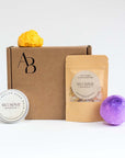 Awesome Botanical Monthly subscription box on white background with 4 products in front of the kraft box