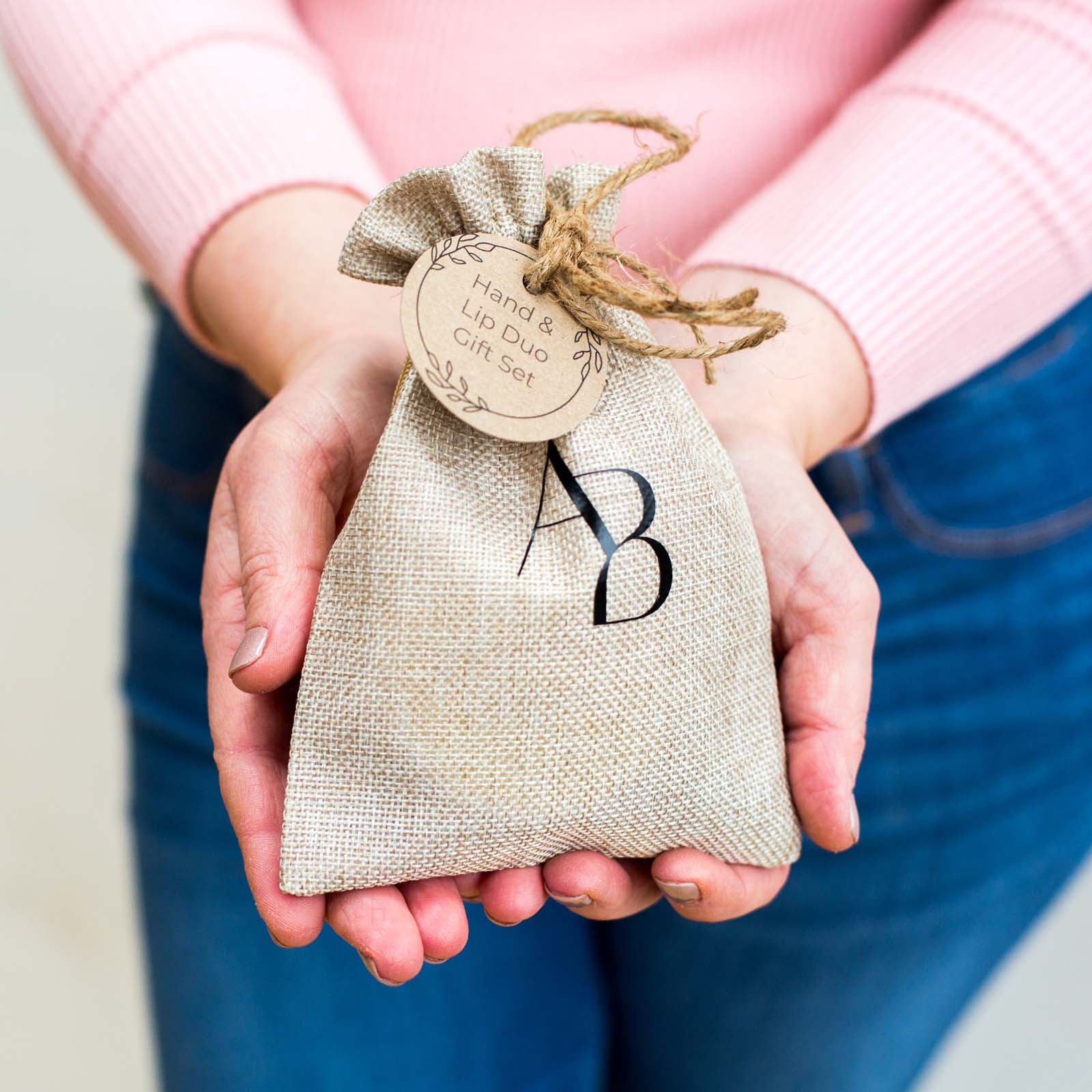 Branded Awesome botanical hessian bag with gift tag in hands