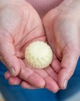20g hand balm in hands in shape of a flower