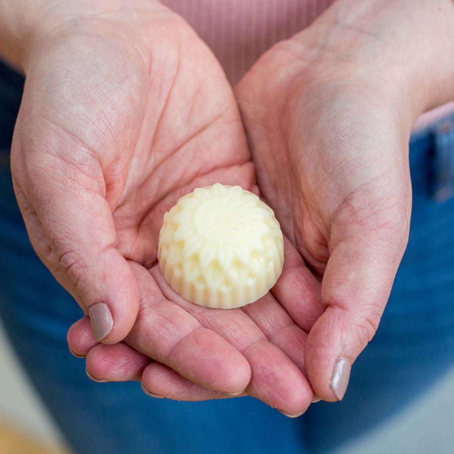 20g hand balm in hands in shape of a flower